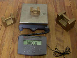 The 1 kilogram mass on the digital scale for calibrating it.