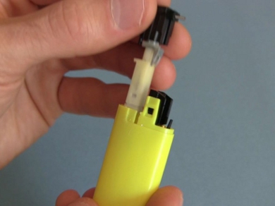 Pulling a piezoelectric igniter from a lighter.