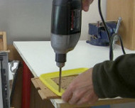 Drilling holes for bolts.