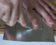 Cutting the metal plate.