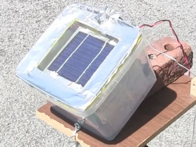Solar cell in a container filled with mineral oil for keeping the cell cool.