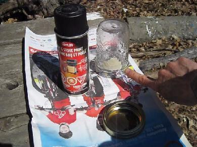 Painting the solar cooking jar with tape for a window.