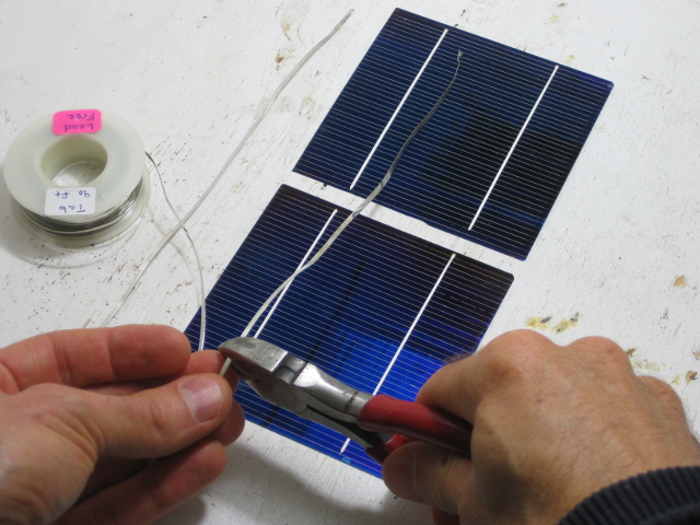 Cutting the strips of tabbing for my DIY/homemade solar panel.