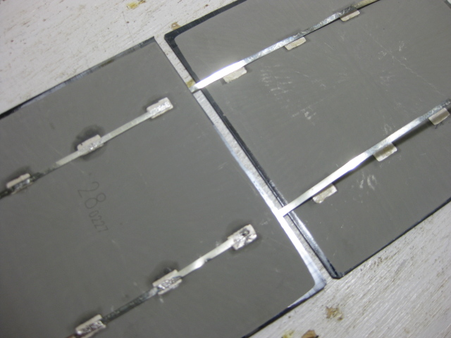 Two solar cells placed near each other in preparation for soldering.