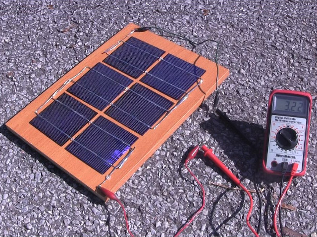 Measuring the solar panel's output using a meter.