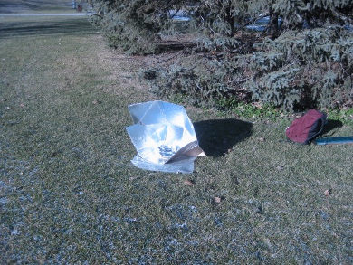 Solar cooking with the Modified CooKit solar cooker in the park.