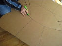 Cutting the cardboard for the
        Modified CooKit solar cooker.