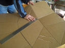 Making the folds for the Modified CooKit 
        solar cooker.