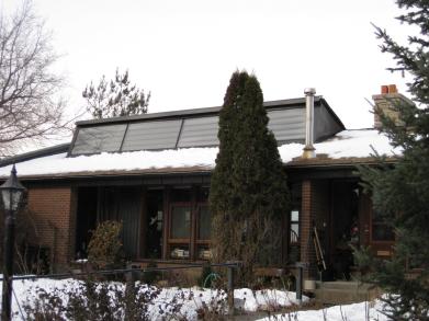 A row of Solarsheat solar air heating panels installed on the roof.