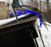 Angled metal flashing used to create a venturi effect with the air to help clean snow from solar air heater panels.