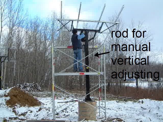 Pole mounted solar array with manual vertical adjustment.