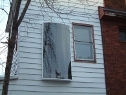 Cansolair solar air heater installed on the side of a house.