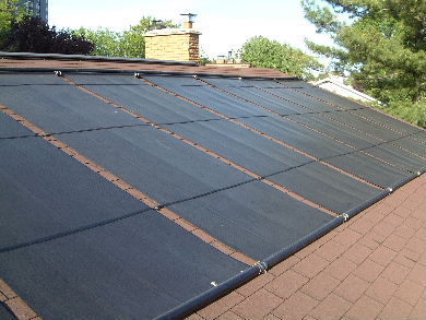 Solar pool heating panels on a roof - view from the roof.
