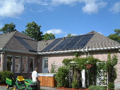 Commercially made solar heat collector panels on a roof.