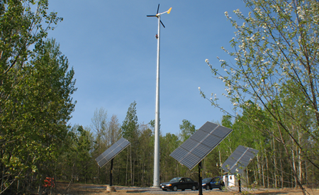 The full wind turbine with solar arrays at its base.