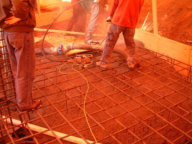 The concrete being poured into the rebar.