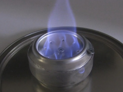 The alcohol stove lit showing the individual flames.