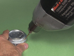 Drilling a hole in the edge of the can for air to leave while
      the alcohol stove is being filled.