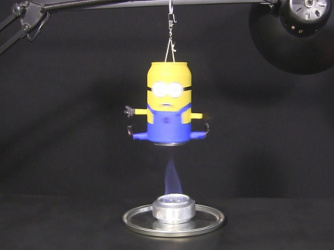 Homemade alcohol stove making a minion Hero's steam engine spin.