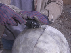 Cutting the fiberglass ball's equator using a thin, round dremel cutting blade.