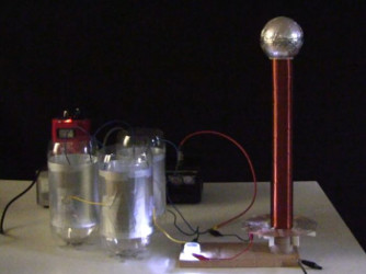 Small spark gap Tesla coil with capacitors made from soda bottles.