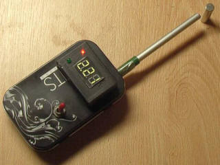 DIY gauss meter on a table with a magnet near its probe.