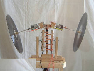 Two gyroscopes made with vinyl records and mounted on a rotating rotor.