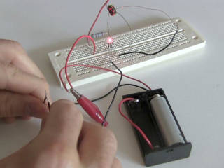 A joule thief circuit powering an LED from a dead battery.