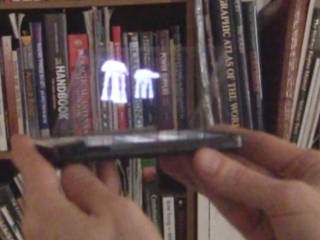 Pepper's ghost using a smartphone showing animations of two Star Wars AT-ATs.
