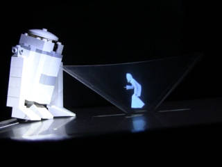 Pyramid hologram/pepper's ghost of princess leia with a LEGO R2D2 beside it.