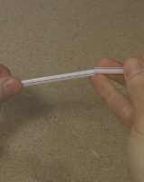 One straw fits inside another for making the straw trombone.