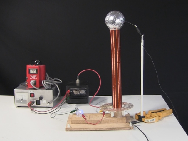 Small spark gap Tesla coil with spiral primary and DIY flat capacitors.