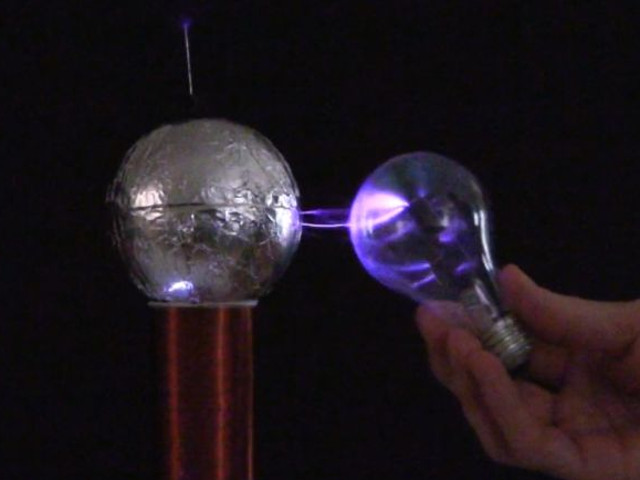 Incandescent lightbulb powered by a spark gap Tesla coil.