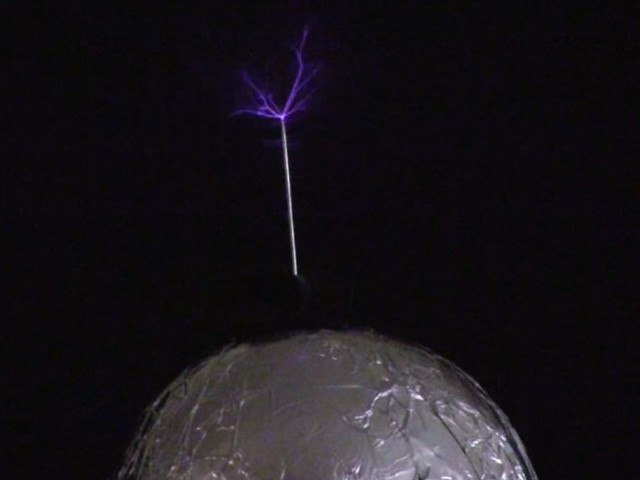 Streamers coming from the topload of a spark gap Tesla coil.