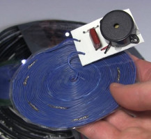 Piezo buzzer capacitor and diode connected to receiver coil for receiving transmitted energy.