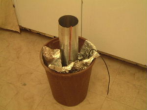 The electric field thruster and mold sitting in a bucket to
      avoid a mess if the wax leaks from the mold.