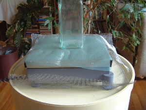 The digital scale with grounded fine wire mesh acting as a 
      Faraday cage.