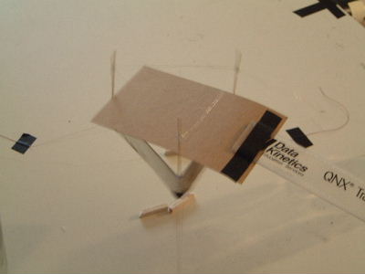 Testing the lifter's source of propulsion by using a piece of cardboard to block ion wind.