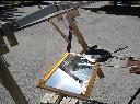 Fresnel lens and mirror solar cooker.