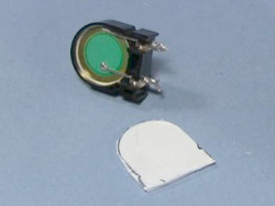 The exposed piezoelectric crystal from the microwave oven's       piezo speaker and the homemade plastic cover.