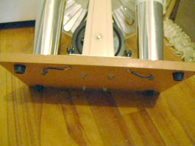 Showing how the outer cylinders of the two Wimshurst machine Leyden jars are connected together with a bus bar above the base board and wires underneath the board..