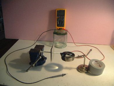 The setup for measuring the capacitance of an air dielectric 
      capacitor with a digital multimeter (DMM).