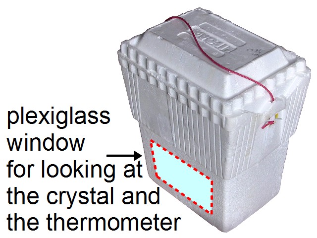 Styrofoam container with plexiglass window for seeing crystal growing inside.
