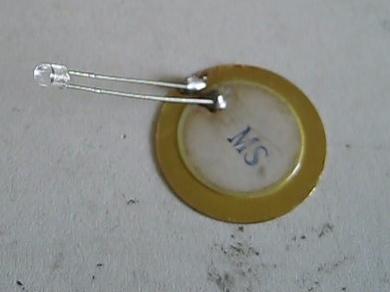 Piezoelectric disk taken from a gift card speaker, with diode attached.