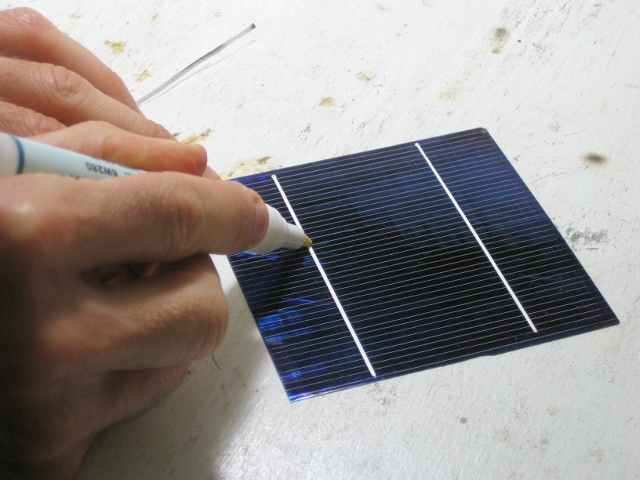 Applying flux using a flux pen to the front of a solar cell for my DIY/homemade solar panel.
