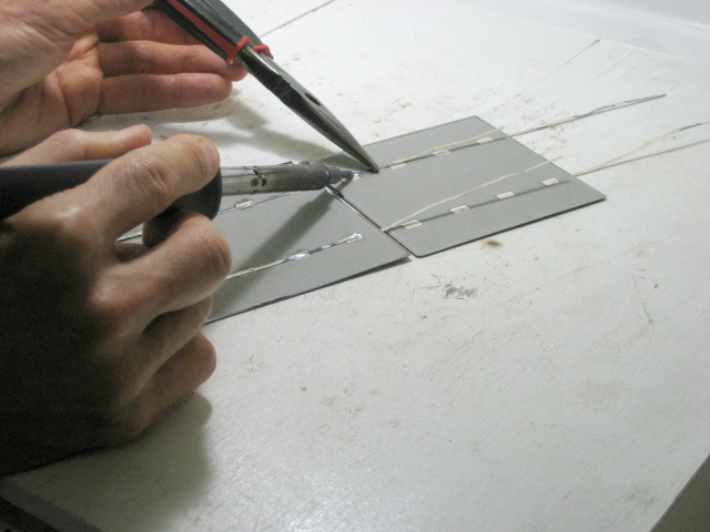 Soldering one solar cell to the next.