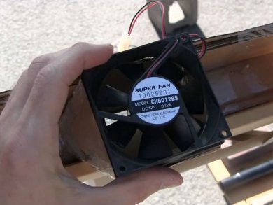PC fan attached to the mini screen solar air heater's hot air outlet.