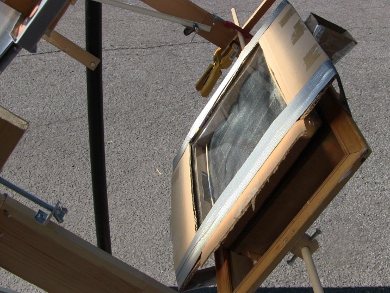 Mini solar tower (a mini screen solar air heater) mounted in place so that the fresnel lens can focus light onto it.