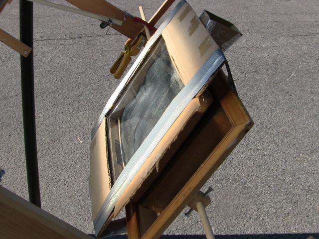 Mini solar tower (a mini screen solar air heater) mounted in place so that the fresnel lens can focus light onto it.