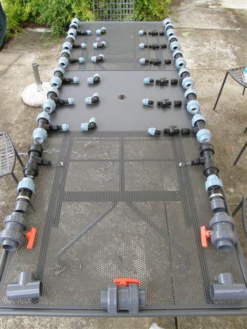 PVC pipework fittings layout before installation in solar pool heating system.